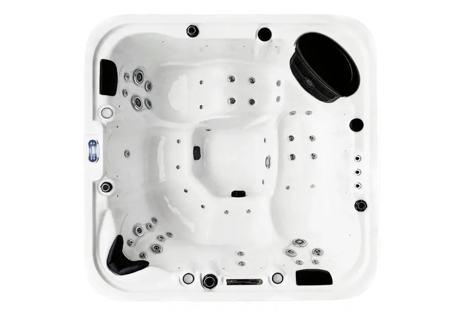 Spa Tropic Spas Key Largo von oben, mit weißer Wanne, geformten Sitz- und Liegeplätzen und Massagedüsen.