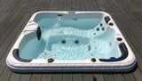 Witte jacuzzi buiten met 5 zitplaatsen, jetstreams en geïntegreerde zwemspa functies.